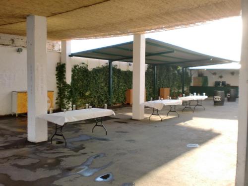 a row of white tables in a building at Hostal las Tres Jotas in Alcaracejos