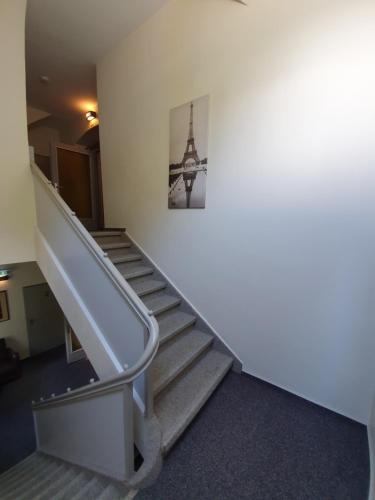 a staircase in a building with a picture of the eiffel tower at Hotel Bergschlösschen in Boppard