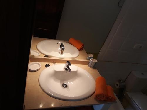 a bathroom with two white sinks and a mirror at Casa Rural Altozano de Buendia in Buendía