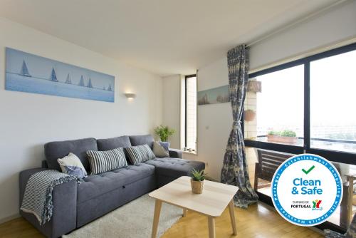 a living room with a couch and a table at Host Wise - Amazing Comfy Flat with Balcony in Matosinhos