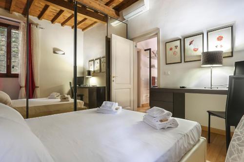 a bedroom with a bed and a mirror in a room at CELLINI Bright & Elegant flat in Florence-hosted by Sweetstay in Florence