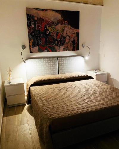 a bedroom with a bed and a painting on the wall at Room 26 - B&B Altamura in Altamura