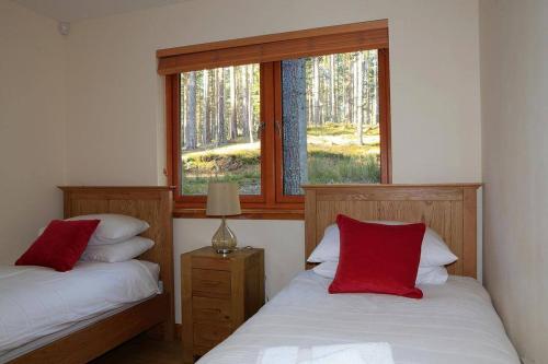 A bed or beds in a room at Cairngorm Lodges