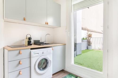a laundry room with a washer and dryer next to a window at Les Studios Blancarde Terrasse Parking Clim Métro in Marseille