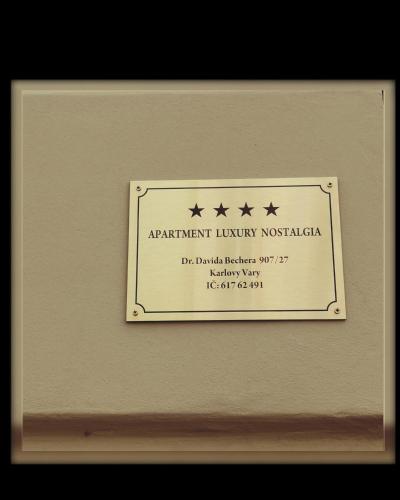 a plaque with four stars on a wall at Apartment Luxury Nostalgia in Karlovy Vary