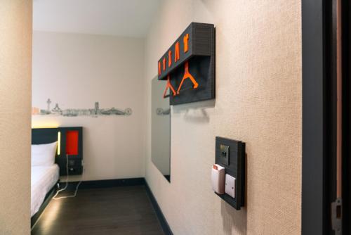 a room with a bed and a clock on the wall at easyHotel Liverpool in Liverpool