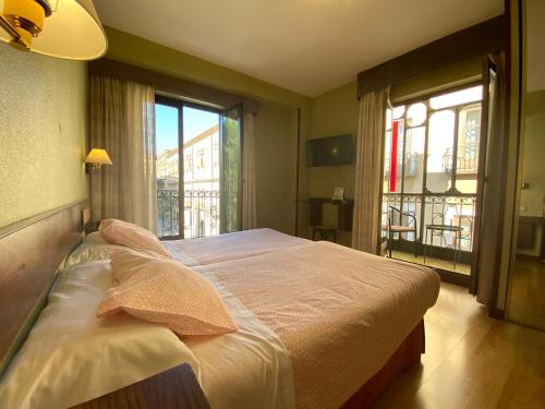 Postel nebo postele na pokoji v ubytování Hostal Concejo