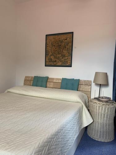 a bedroom with a bed and a picture on the wall at Casa Diana Arianna in Lipari