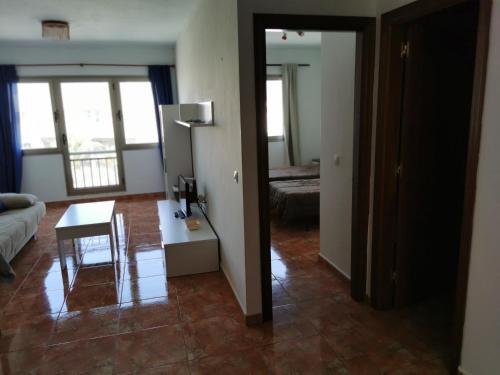 a living room with a table and a couch at Cotillo Faro in Cotillo