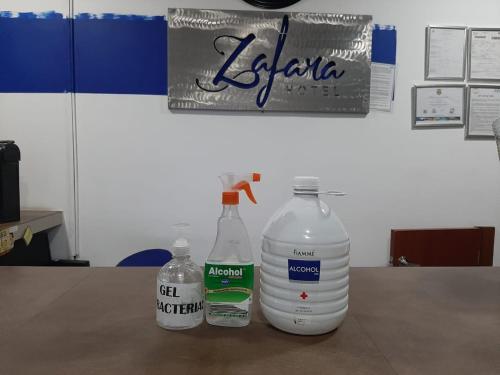three bottles of water sitting on top of a table at Zafara Hotel in Santa Marta