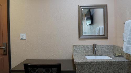 a bathroom with a sink and a mirror at Holly Crest Hotel - Los Angeles, LAX Airport in Inglewood