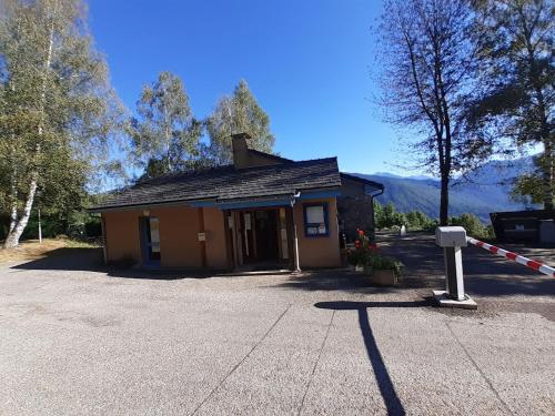 a small brown building with a sign in front of it at Camping Municipal La Prade in Sorgeat