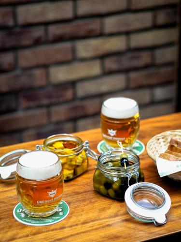 two glasses of beer sitting on a wooden table at Absolutum Wellness Hotel in Prague