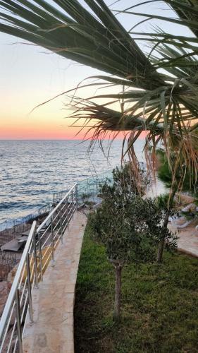 a pathway leading to the beach at sunset at Your Home Montenegro in Dobra Voda