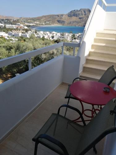 a balcony with a table and chairs and a view at Eleonas in Plakias