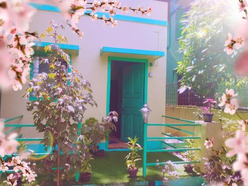 a dog standing at the door of a house at Dden Vennell BnB -Metro Access- in Kolkata
