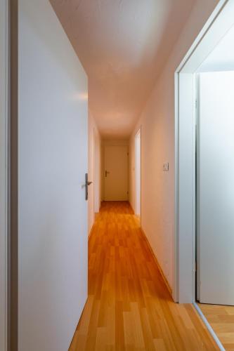 an empty hallway of an apartment with a door and wooden floors at Holiday country house Gora in Gozd