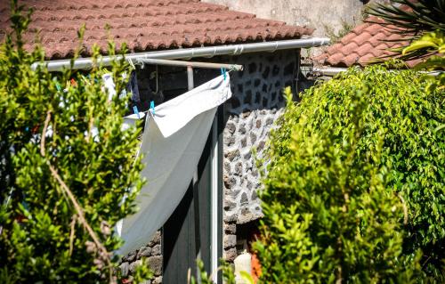 a white shirt hanging on the side of a house at Quinta dos Frutos in Santa Cruz da Graciosa