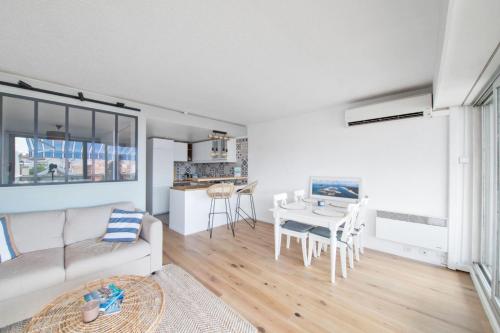 un salon avec un canapé blanc et une table dans l'établissement Appartement de la Jetée - Welkeys, à Arcachon