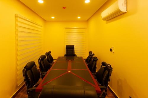 a conference room with a table and chairs in it at Hera in Wuse