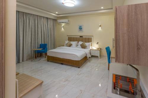 a hotel room with a bed and a fireplace at Hera in Wuse