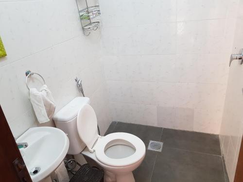 uma casa de banho com um WC branco e um lavatório. em Casa Naranja em San Lorenzo