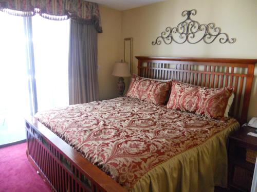 a bedroom with a large bed with red pillows at Oak Square 201 in Gatlinburg