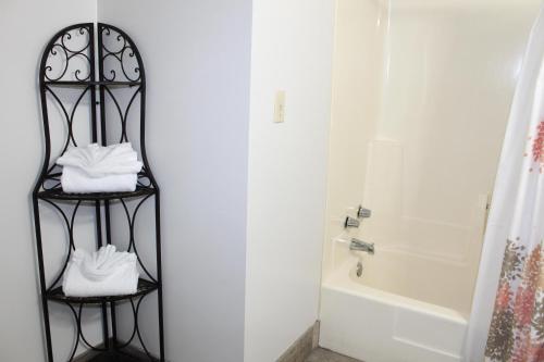 a bathroom with a black towel rack next to a bath tub at Oak Square 210 in Gatlinburg