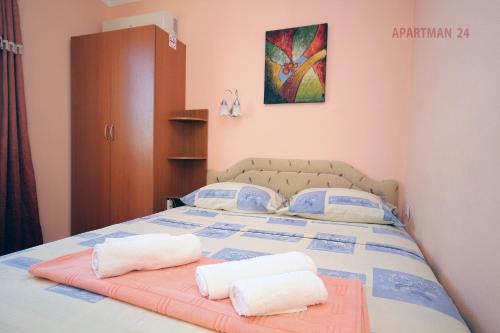 a bedroom with a bed with two towels on it at Apartments Kojic in Bar