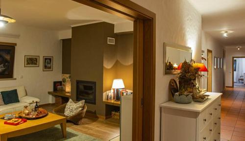 a living room with a couch and a table at Casa Limonina in Louriçal