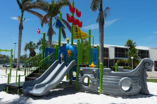 a playground on the beach with palm trees at Kawama Yacht Club Apartment in Key Largo