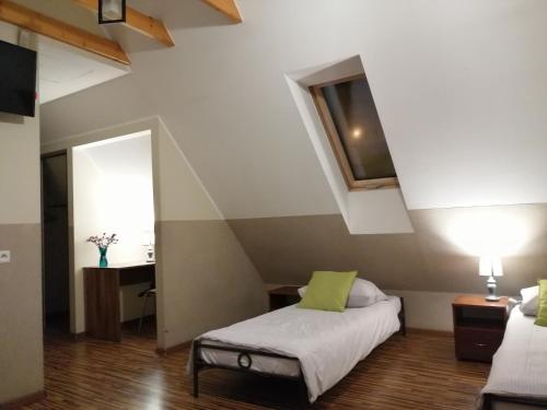 a bedroom with a bed and a table and a window at Pokoje Gościnne z Prywatną Łazienką dla firm in Gliwice