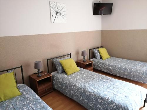 a bedroom with two beds and two lamps at Pokoje Gościnne z Prywatną Łazienką dla firm in Gliwice