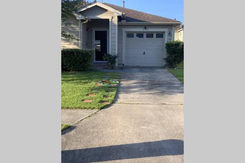a driveway in front of a house with a garage at House 8122 in Humble