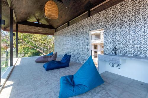 an outdoor kitchen with blue pillows and a tub at Luxury Ocean-View Flamingo Home with Pool, Apartment and Party Deck in Playa Flamingo