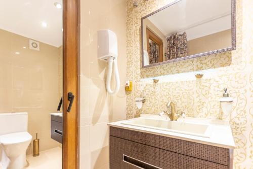 a bathroom with a sink and a mirror at Benalbeach Premium Small Studio- 24h access in Benalmádena