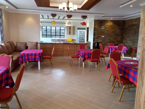 a dining room with red and blue tables and chairs at Villa Serene Hotel in Kitale