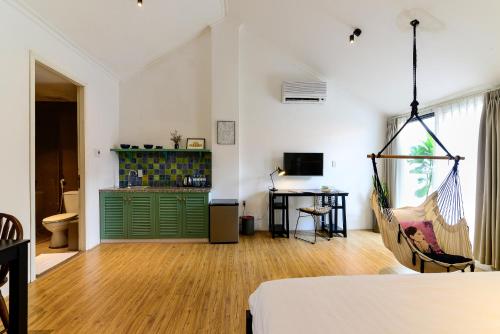 a bedroom with a green door and a desk in a room at Leaf Signature Hotel - Lá Group in Ho Chi Minh City