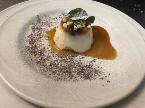 a white plate with a dessert on a table at Hotel Pietrapanna in Calvello