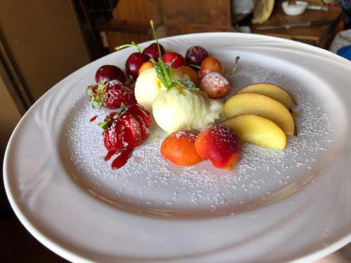 a plate of fruit on a white plate at Hotel Pietrapanna in Calvello