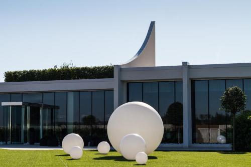 a building with a large white object in front of it at Pineta Hotel in Monsano