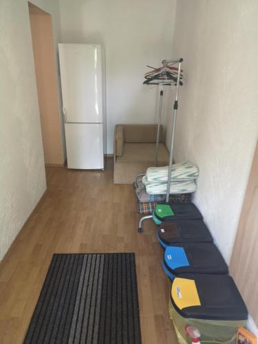 a room with a room with a refrigerator and a couch at Dom wczasowy Rychertówka in Grzebieniec