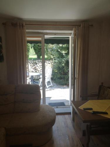 a living room with a door open to a patio at Dom wczasowy Rychertówka in Grzebieniec