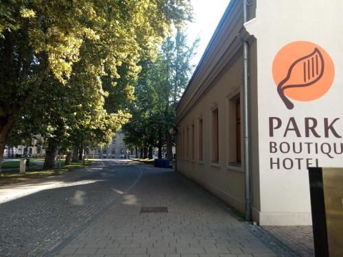 a sign on a sidewalk in front of a building at Park Boutique Hotel in Varaždin