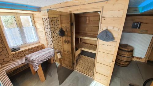 an overhead view of a wooden cabin with a bench at Magic House Under Arber in Bayerisch Eisenstein