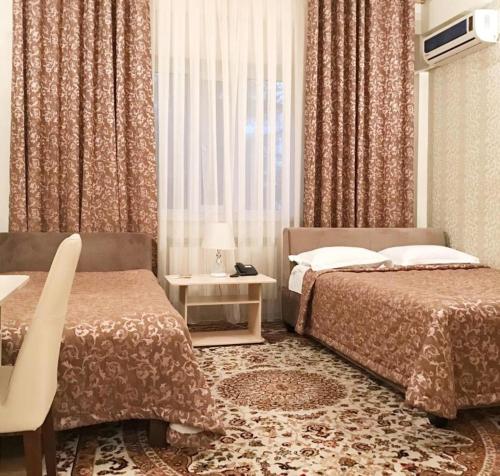 Кровать или кровати в номере Rich Hotel