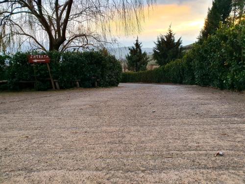 a dirt road with a sign in the middle at Agriturismo Leanza "La Baita" in Cesarò