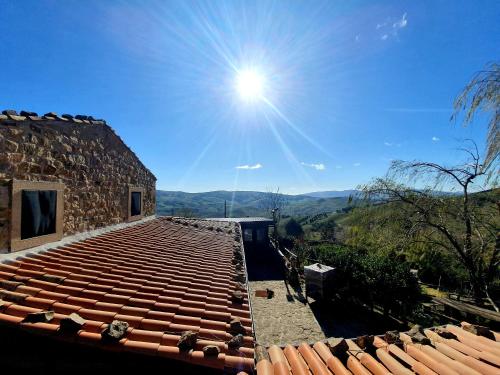 a view from the roof of a building with the sun in the sky at Agriturismo Leanza "La Baita" in Cesarò