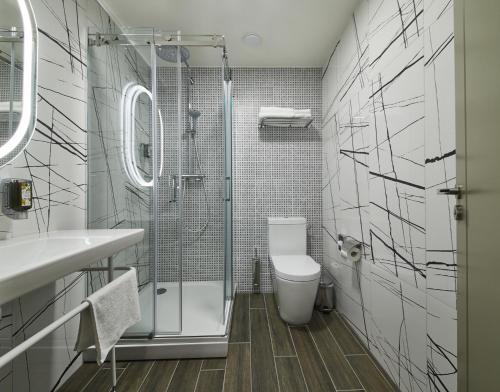 a bathroom with a shower and a toilet and a sink at Kaunas in Kaunas