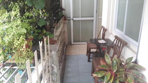 a balcony with a table and chairs and a door at Green Homestay in Hanoi